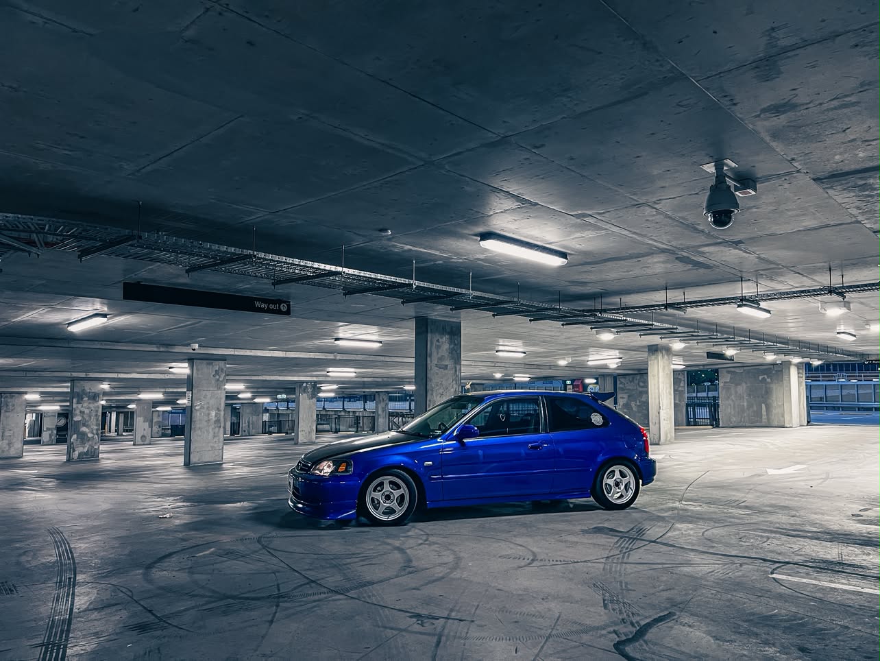 Side view of the blue EK1 Civic POGI showing its stance and wheels