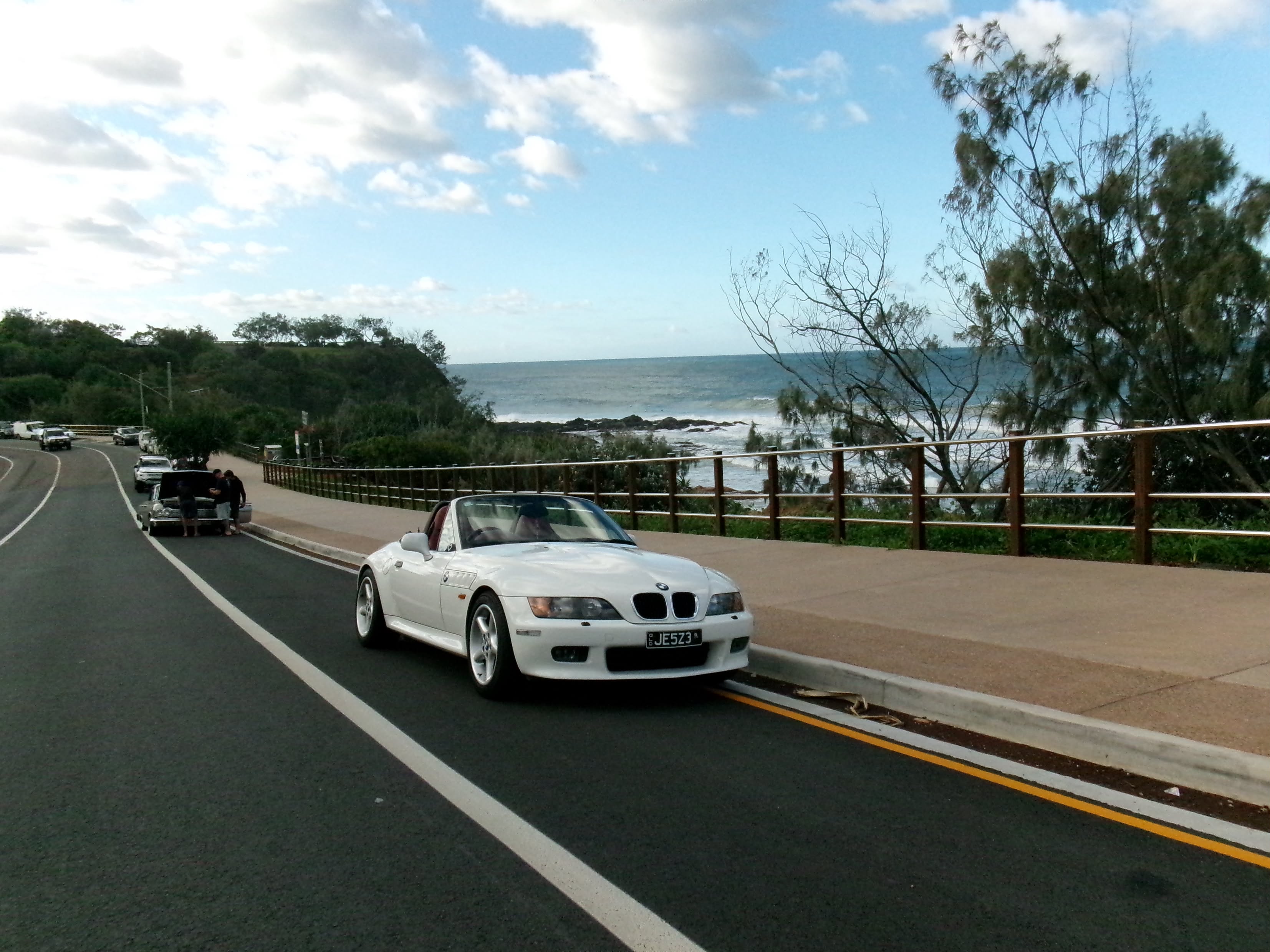 Jess’s white BMW Z3 parked beside the coast