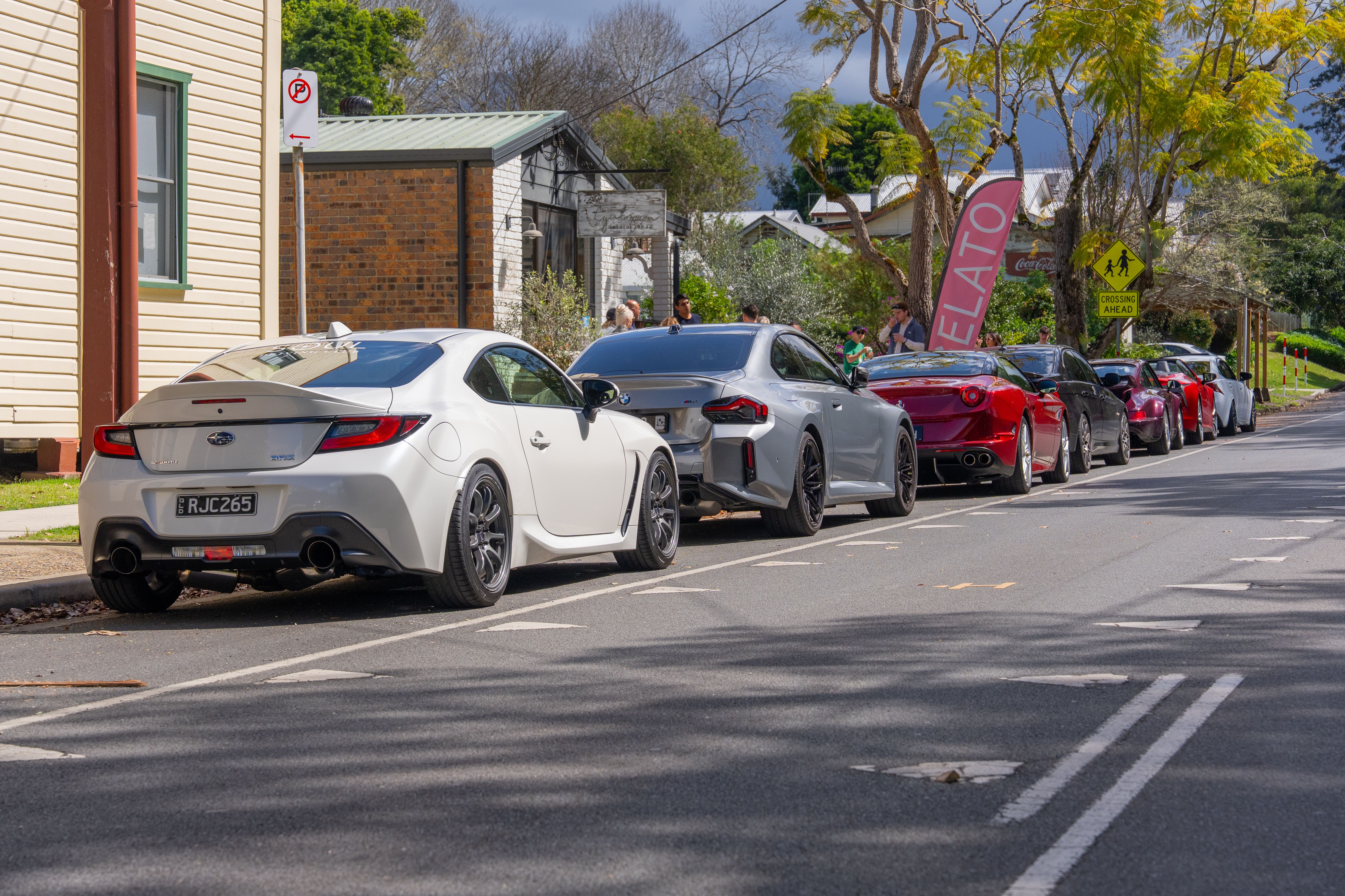 Soul Driving Club cars lined up along a village street