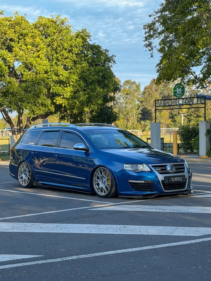 Timone’s blue Passat R36 from the front three-quarter angle beside a tree-lined street