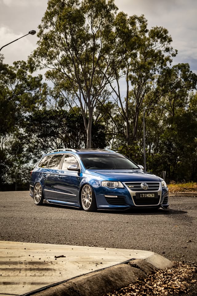 Blue Passat R36 photographed from the front on a quiet tree-lined road